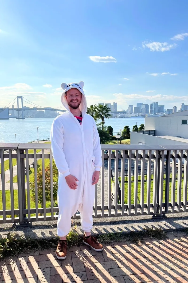 Mann in süßem Anime Onesie am Hafen in Tokio